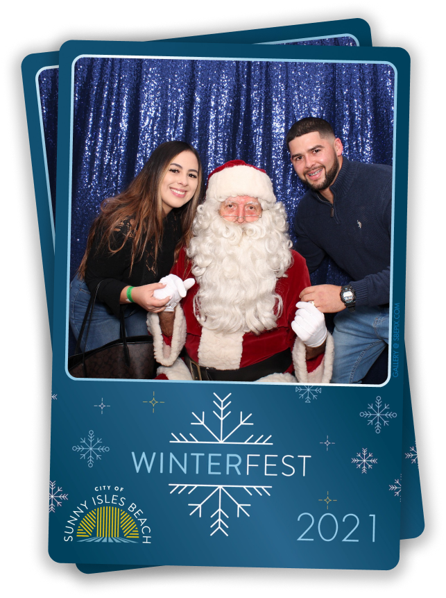 A woman and a man pose with Santa Claus in front of a sparkling blue backdrop at the Winter Holiday Party. The photo booth captures festive memories, framed with Winterfest 2021 text and the City of Sunny Isles Beach logo, featuring a sun and waves.