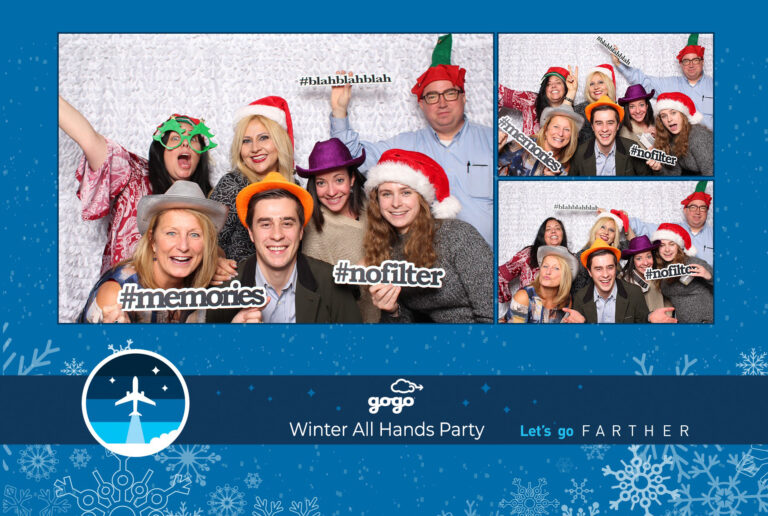 A group of people wearing festive hats poses enthusiastically at a photo booth during the Gogo Holiday Party. They hold signs saying memories and no filter against a snowflake-themed backdrop. Text at the bottom reads: Gogo Winter All Hands Party - Let's go Farther.