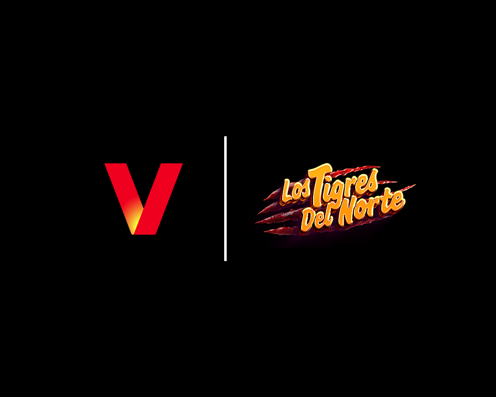 A red V-shaped logo sits left of a vertical white line, with the Los Tigres Del Norte band logo on the right—perfect for an AI Photo Booth Las Vegas Trade Show, set against a black background.